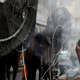 A man stands by fans spraying air mixed with water vapor deployed by donors to cool down pedestrians along a street in Iraq's capital Baghdad on June 30, 2021 amidst a severe heat wave.